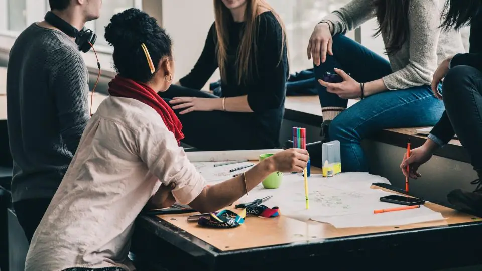 International students studying together around a table