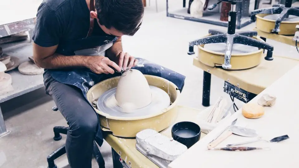 Trainee working with hand tools at a workshop bench