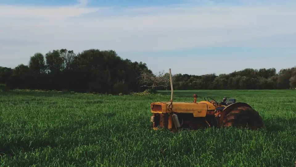 Tractor working in green farmland in a regional area