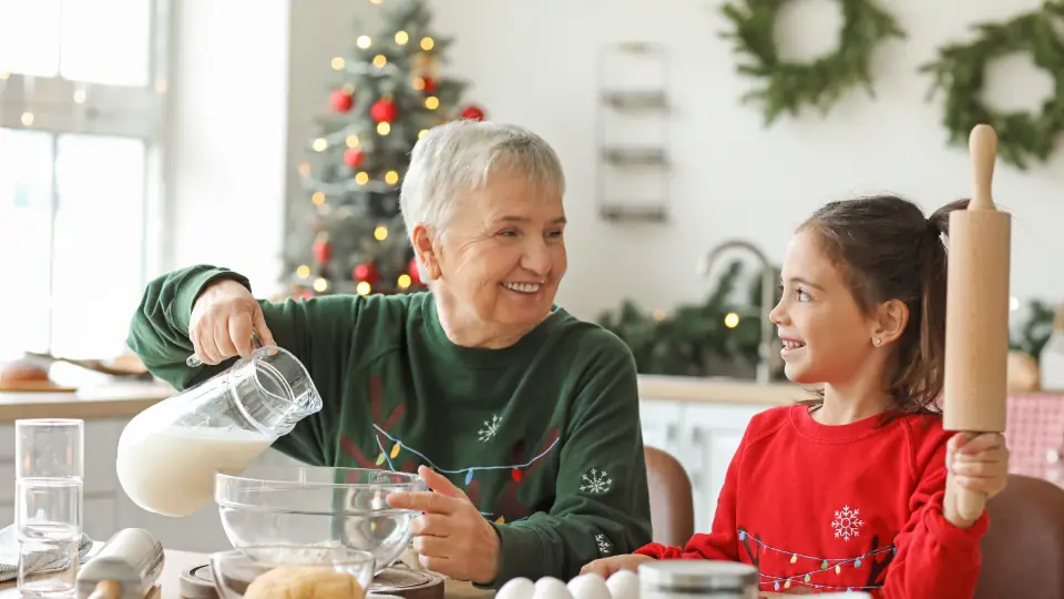 Grandmother and granddaughter baking together in a home kitchen