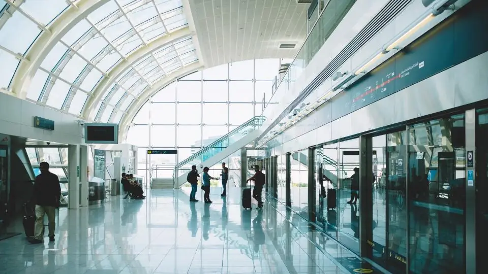Travellers walking through a bright modern airport terminal
